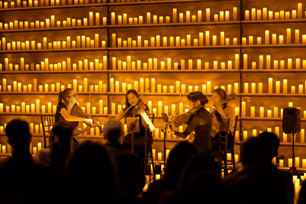 String quartet performs surrounded by candles