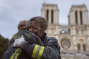 La Nuit de Notre Dame Season 1-firefighters-hugging-outside-notre-dame-cathedral-in-paris-a-netflix-series-is-available-to-stream-this-october