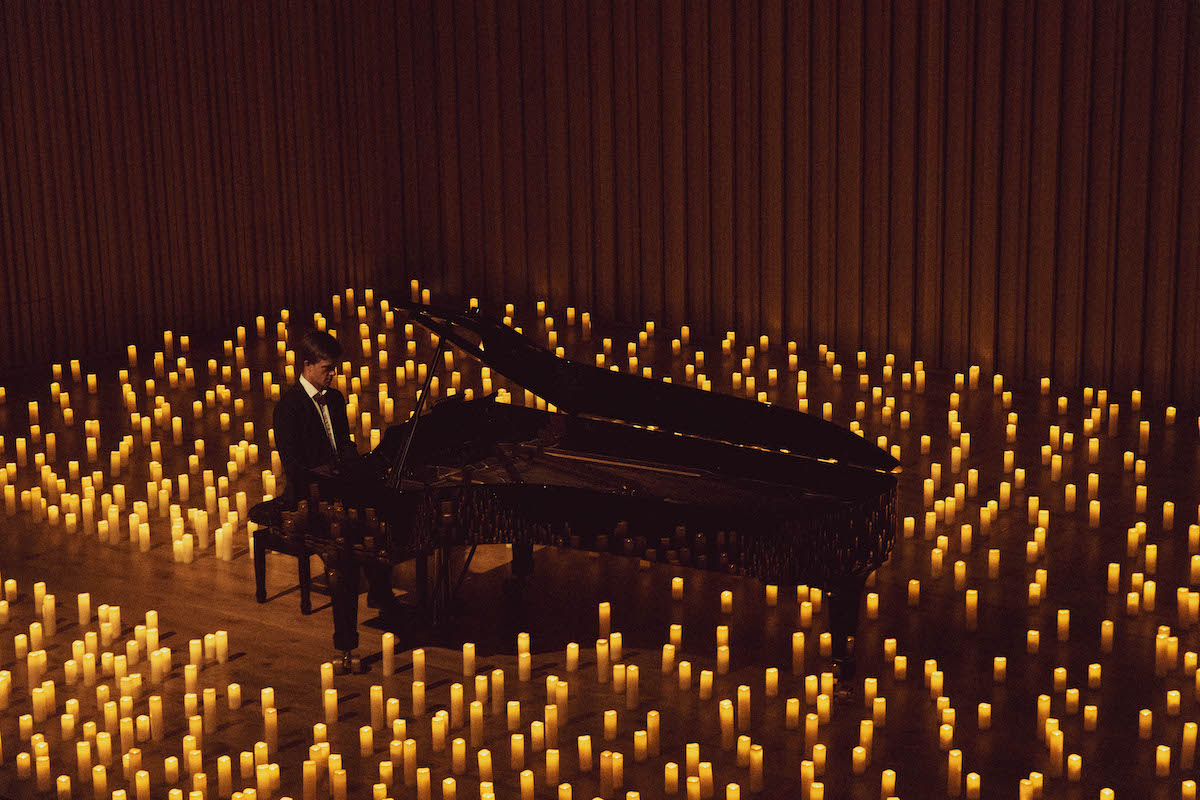 pianist performs among candlelight in Stoller Hall