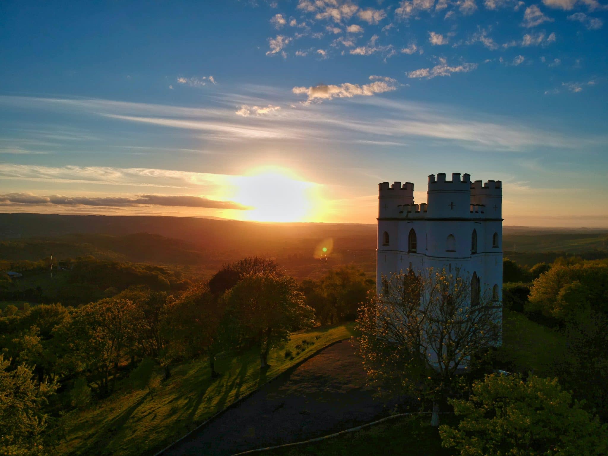 A beautiful castle with the sun setting in the background in Dartmoor
