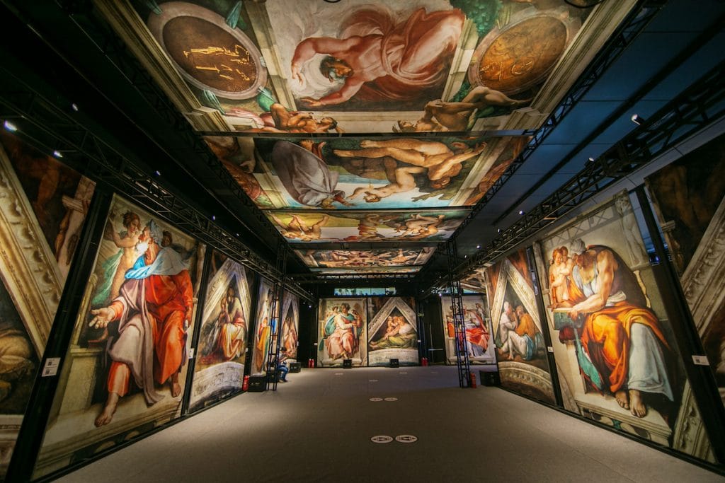 Large scale sections of Michelangelo's Sistine Chapel hang on the walls and ceiling