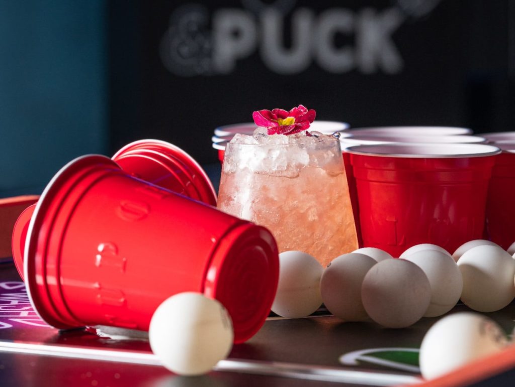 beer-pong-cups-and-ping-pong-balls-on-table-with-cocktail-at-pong-and-puck-serving-date-ideas-for-valentines-day