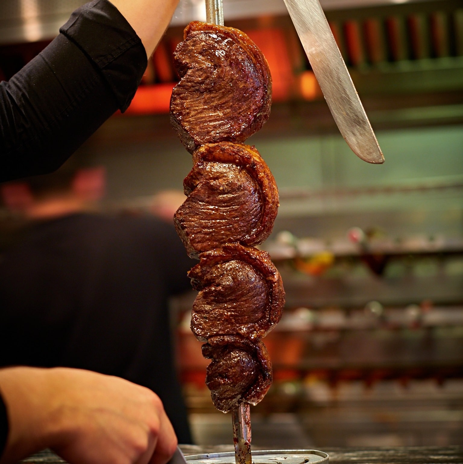 Meat being sliced at Manchester's rodizio restaurant, Bem Brasil
