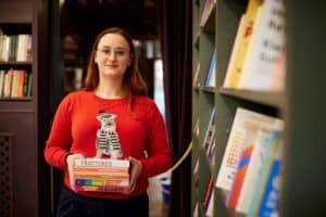 woman-holding-stack-of-books