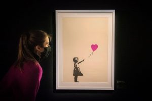 person-looking-at-girl-with-heart-balloon
