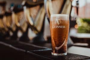 guinness-pint-settling-on-bar-with-harps-in-background