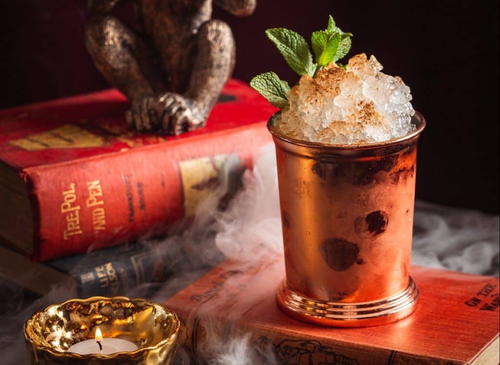 moscow-mule-cocktail-on-top-of-book-by-tealight-at-rendition-who-are-hosting-a-secret-party