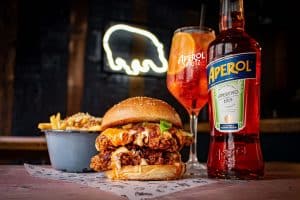 fat-hippo-chicken-burger-with-fries-and-bottle-of-aperol-and-lass-of-aperol-spritz