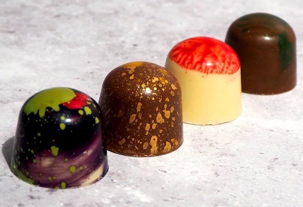 row-of-four-different-flavours-of-manchester-themed-chocolates