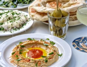 firehouse-selection-of-food-and-drink-including-olives-plate-of-hummus-flatbreads-andcocktails