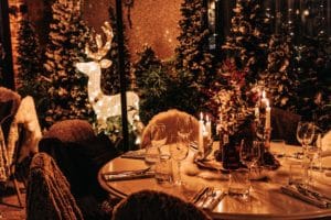 black-friar-winter-tavern-set-table-with-faux-furs-on-chairs-and-twinkling-reindeer-light-in-background