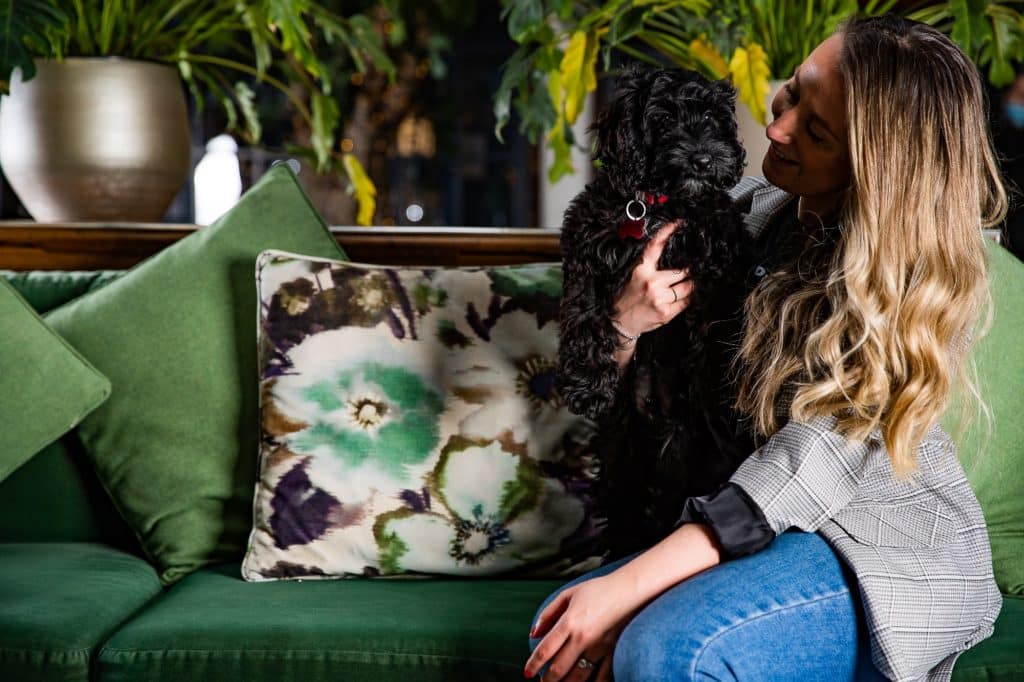woman-holding-dog-at-kimpton-clocktower-hotel-which-is-offering-a-bonfire-night-package-for-dogs