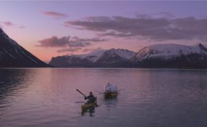 film-still-from-the-north-drift-people-paddling-on-canoes-across-lake-a-film-being-premiered-at-uk-green-film-festival-2022