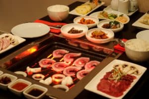 koreana-korean-bbq-meat-on-grill-with-sides-in-background