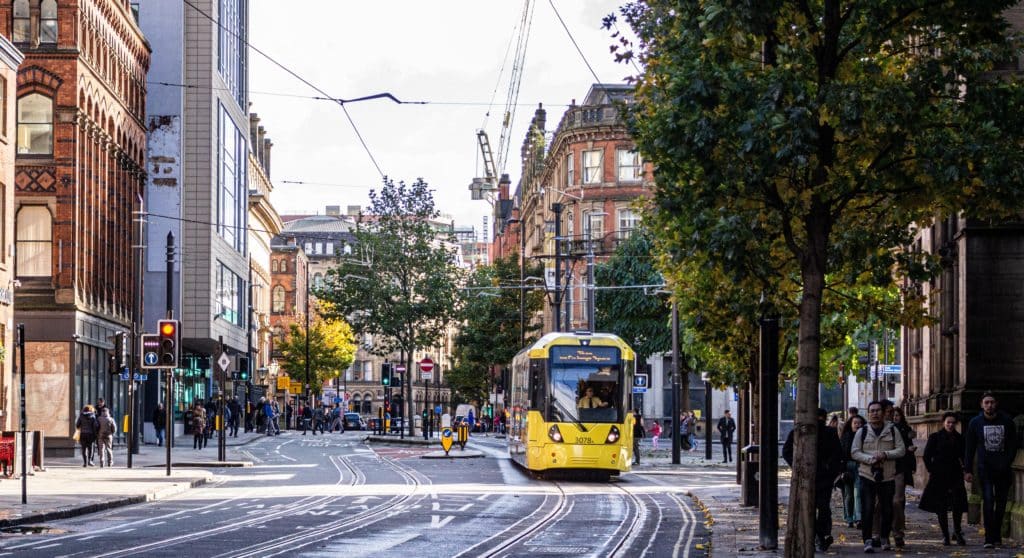 manchester-city-centre-with-tram-passing-the-city-was-named-the-best-destination-to-visit-in-2023-by-national-geographic