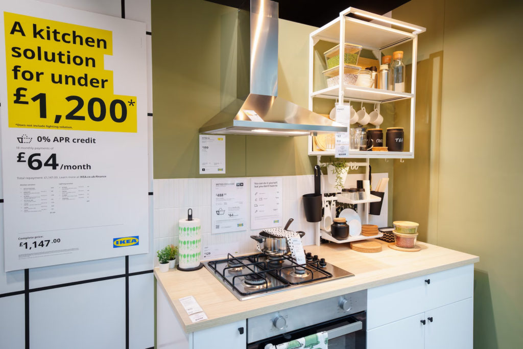 white-kitchen-with-open-shelves-and-extractor-hob-yellow-sign-at-ikea