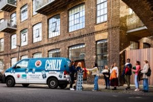 a-line-of-people-exchanging-clothes-for-beer-atcamden-chilly-traid-off-van
