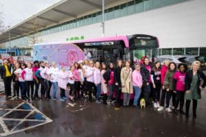 attendees-trustees-stood-in-front-of-pink-boobee-bus-at-asda-to-encourage-breast-screening-in-manchester
