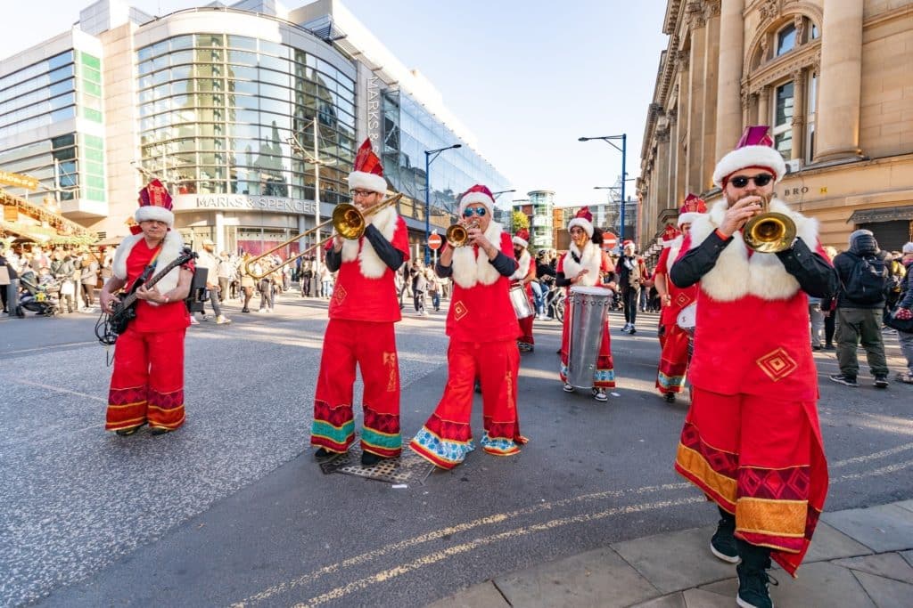 musicians-festive-sundays-christmas-march-through-manchester-city-streets