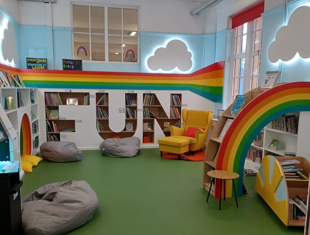z-arts-childrens-library-word-fun-cut-out-of-wall-to-act-as-bookshelves-with-green-carpet-beanbages-and-rainbow-shaped-bookshelf