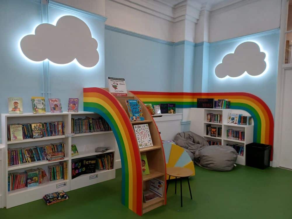 z-arts-childrens-library-in-hulme-with-rainbow-book-shelf-and-cloud-shaped-lights-on-walls