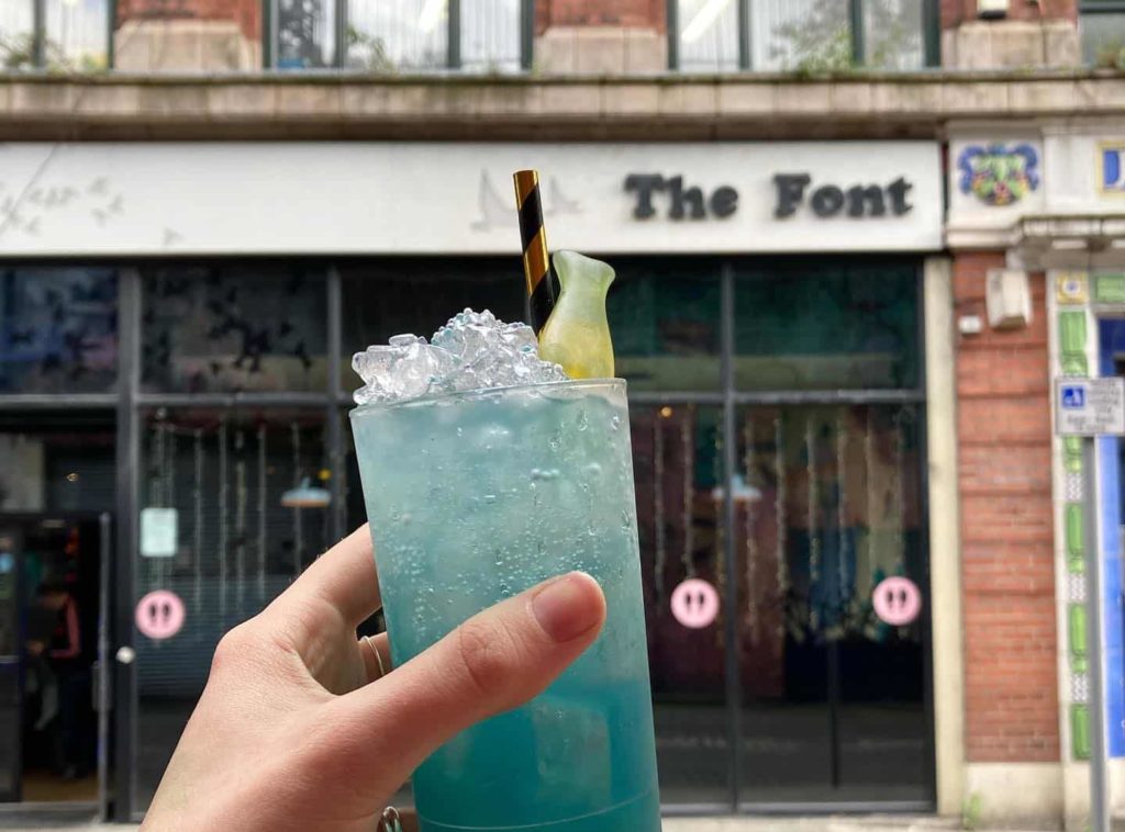 the-font-manchester-with-blue-cocktail-in-hand