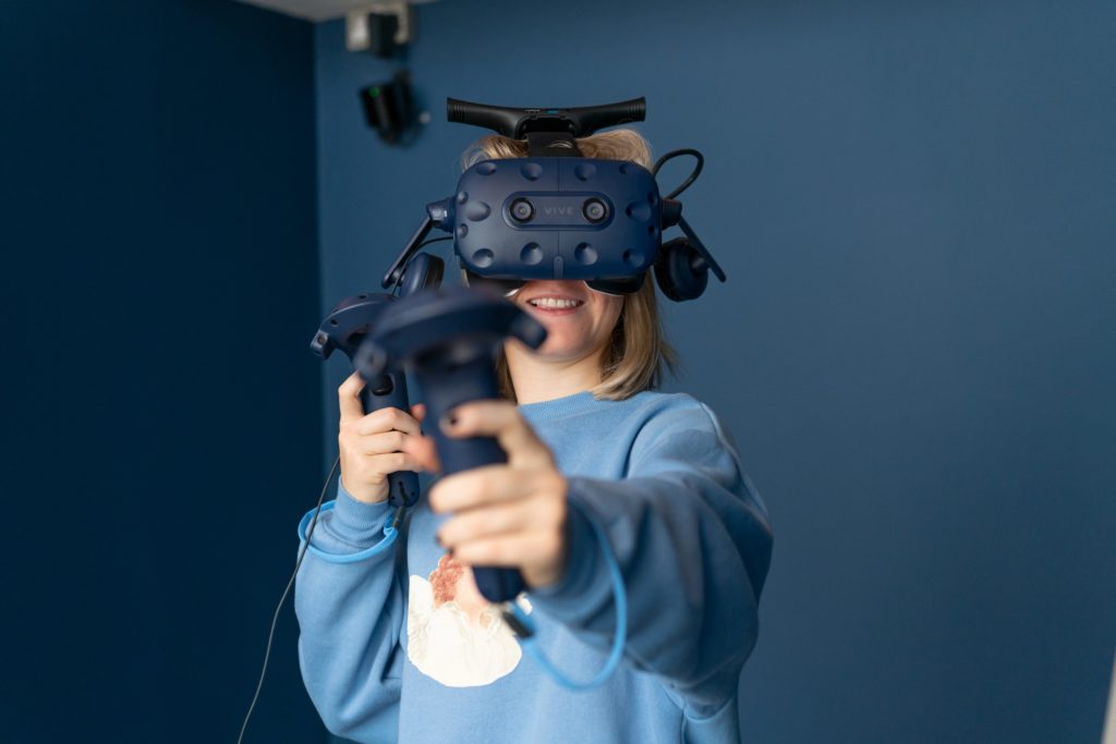 woman-with-vr-headset-on-and-holding-controllers