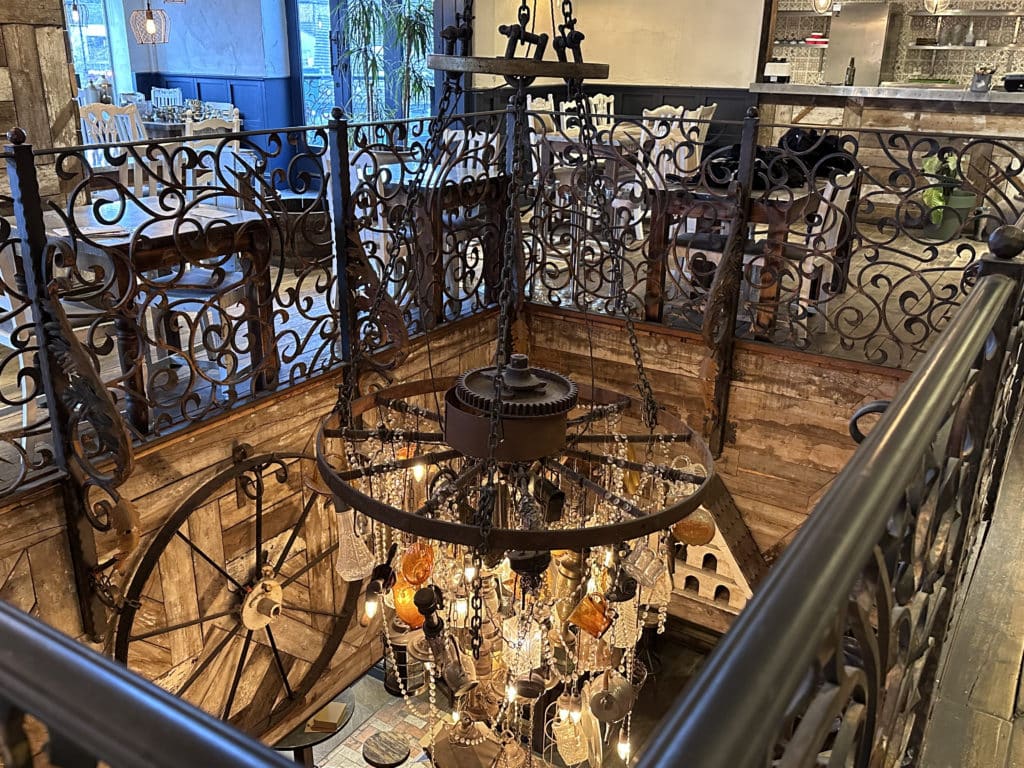 top-floor-dining-area-looking-down-at-ground-floor-via-chandelier