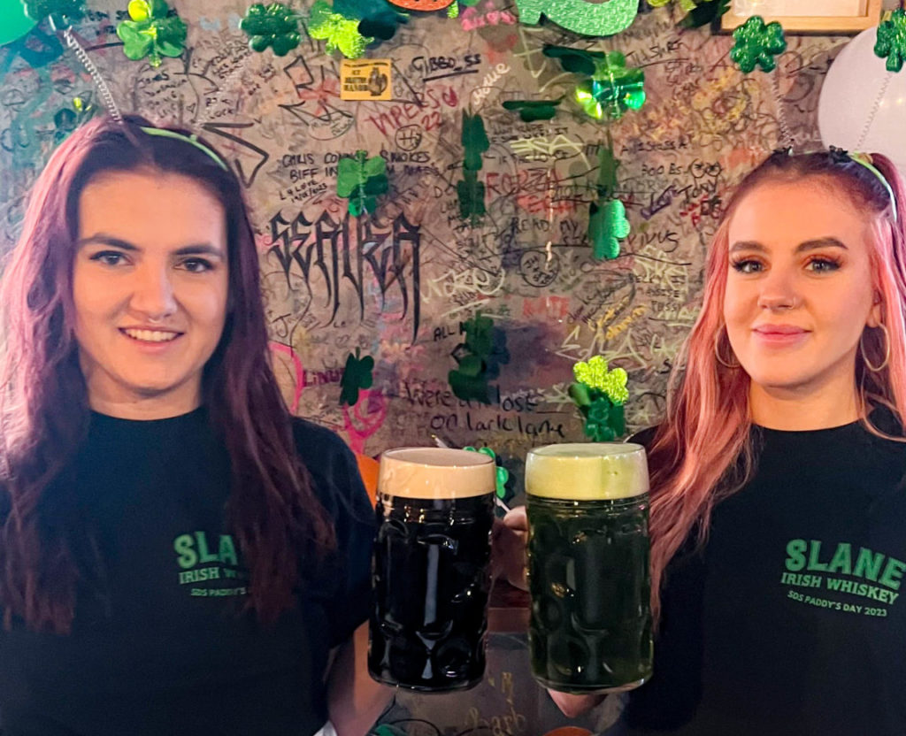 two-women-holding-steins-of-guinness