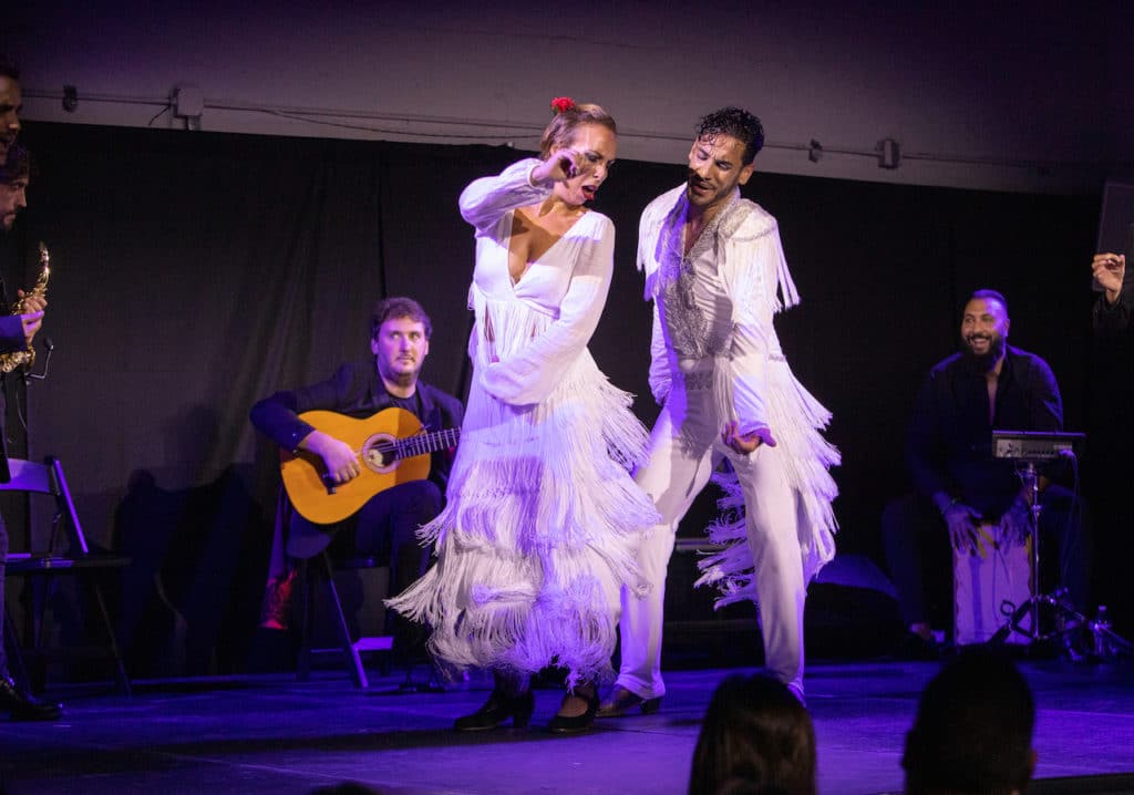 two flamenco dancers performing on stage
