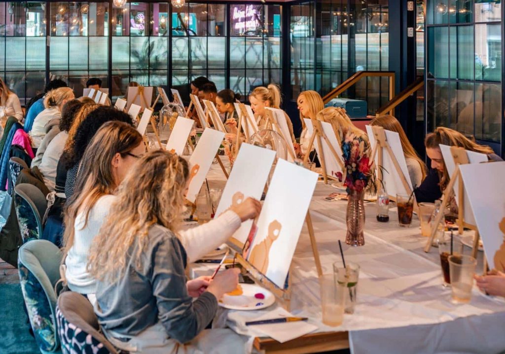 people-painting-on-canvases-at-paint-away-event-classes-manchester