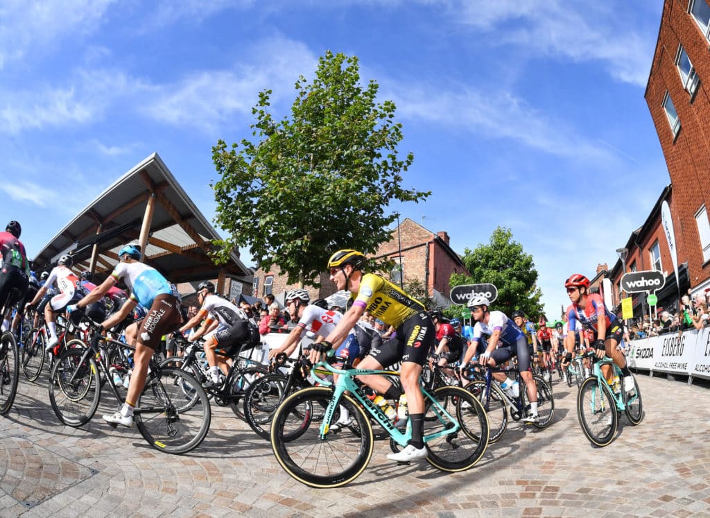 Riders pass Altrincham Marketing in the 2019 Tour of Britain