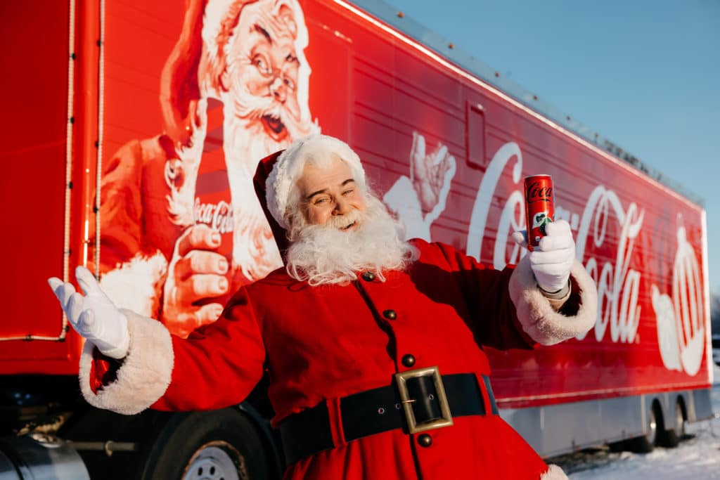 father-christmas-with-bottles-of-coca-cola-in-front-of-truck